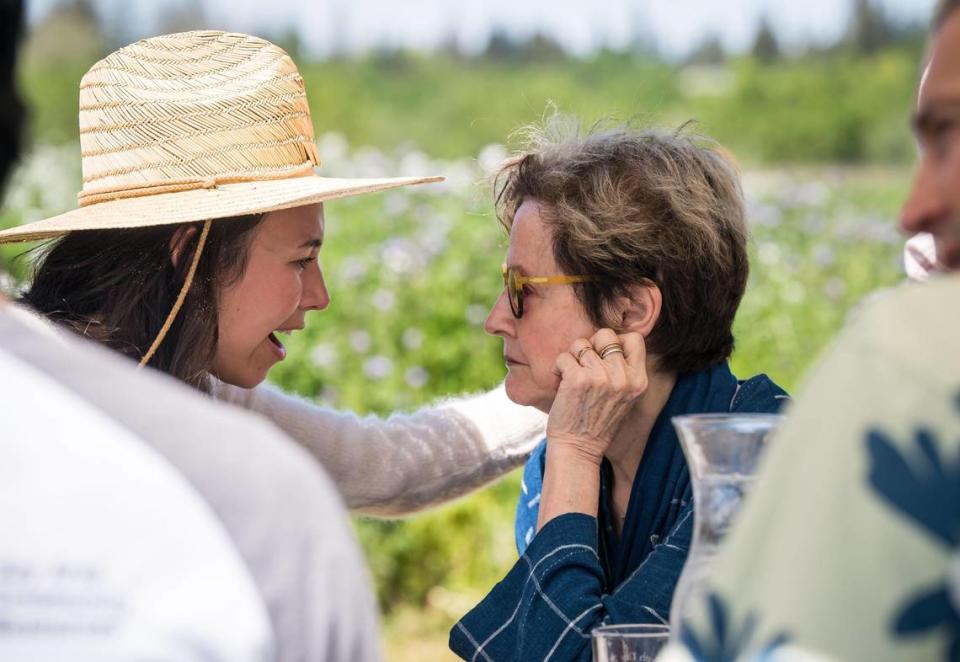 Anna Knight, left, a family farmer with Old Grove Orange, talks with renowned chef Alice Waters, a longtime advocate for local sustainable agriculture and partner in the California Farm to School program, during the Earth Day Celebration hosted by First Partner Jennifer Siebel Newsom at Soil Born Farms on Saturday.