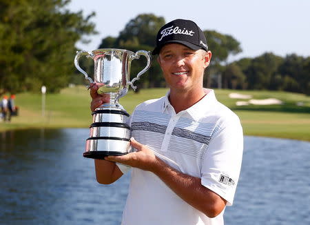 Australia's Matthew Jones poses with the 2015 Australian Open golf trophy after winning the tournament in Sydney, Australia, November 29, 2015. REUTERS/Steve Christo