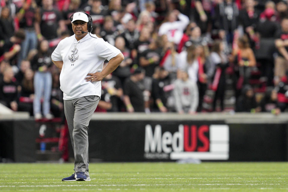 Navy head coach Ken Niumatalolo stands on the field during a stoppage in play in the first half of an NCAA college football game against Cincinnati, Saturday, Nov. 5, 2022, in Cincinnati. (AP Photo/Jeff Dean)