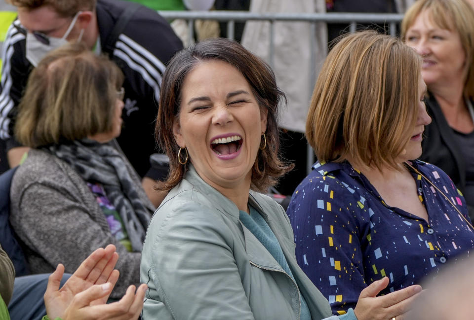 FILE - In this Monday, Sept.20, 2021 file photo, Candidate for chancellor of the Green Party Annalena Baerbock laughs during an election campaign in Mainz, Germany. Germany's election campaign has largely focused on the three candidates hoping to succeed Angela Merkel as chancellor after four terms in office, Annalena Baerbock for the Greens, Armin Laschet for the Christian Union parties and Olaf Scholz for the Social Democrats. German elections will be on Sept.26. (AP Photo/Michael Probst, file)