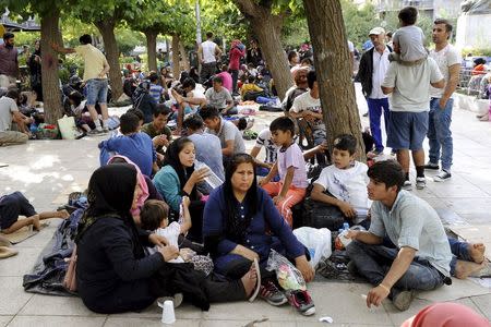 Migrants rest at a square in central Athens after arriving on passenger ships at the port of Piraeus from Lesbos island, September 10, 2015. REUTERS/Michalis Karagiannis