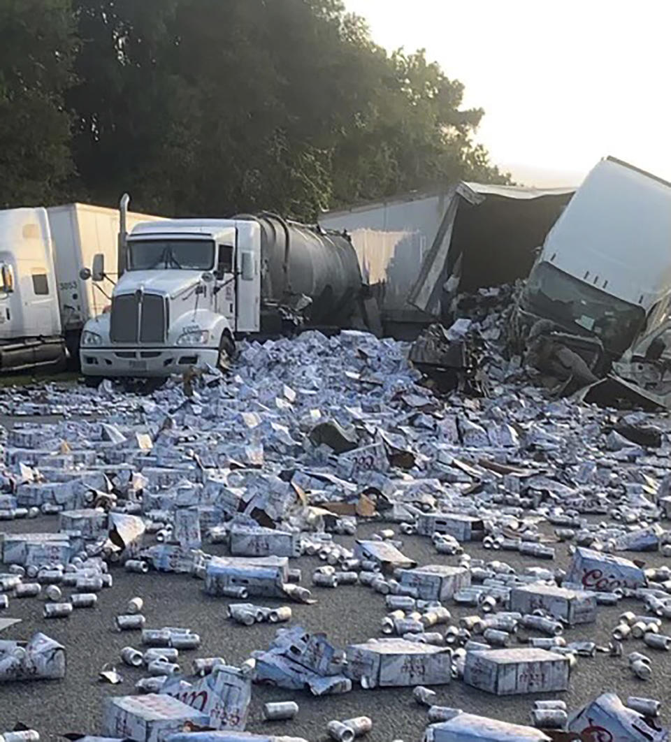 In this photo provided by Florida Highway Patrol, cases of Coors Light beer are strewn across a highway after two semitrailers collided on a Florida highway on Wednesday, Sept. 21, 2022, near Brooksville, Fla. (Florida Highway Patrol via AP)