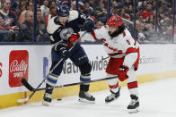 Columbus Blue Jackets' Mathieu Olivier, left, and Carolina Hurricanes' Jalen Chatfield fight for the puck during the second period of an NHL hockey game Tuesday, April 16, 2024, in Columbus, Ohio. (AP Photo/Jay LaPrete)