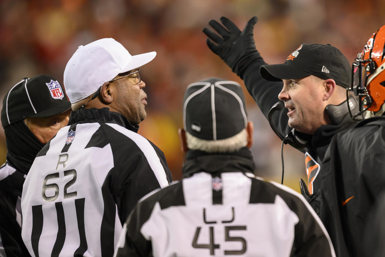 Bengals head coach Zac Taylor seeks an explanation from referee Ronald Torbert (62). (AP Photo/Reed Hoffmann)