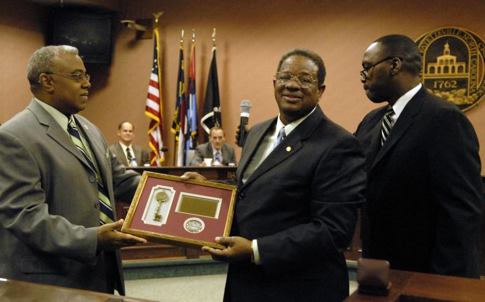 Council member Curtis Worthy, center, receives the keys of the city from Robert A. Massey Jr. Mayor Pro Tem, left, and Council member Charles Evans at the last city council meeting for the out-going council members at City Hall on Monday, Nov. 26, 2007. The Fayetteville City Council honored their out going members Juanita Gonzalez, Curtis Worthy, Paul Williams and Lois A. Kirby with lapel pins and keys of the city.