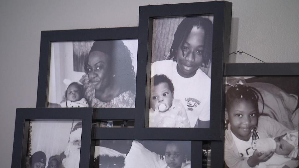Family pictures with Jannai Dopwell-Bailey, who was killed in 2021, adorn the walls of his mother Charla Dopwell's living room.
