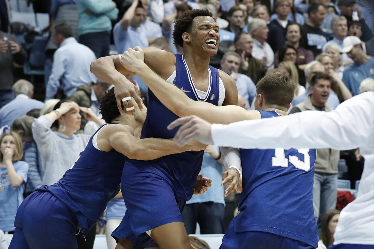 Duke forward Wendell Moore Jr., center, celebrates with guard Jordan Goldwire and forward Joey Baker (13) following Moore's game-winning shot in overtime against North Carolina in Chapel Hill, N.C., on Saturday, Feb. 8, 2020.