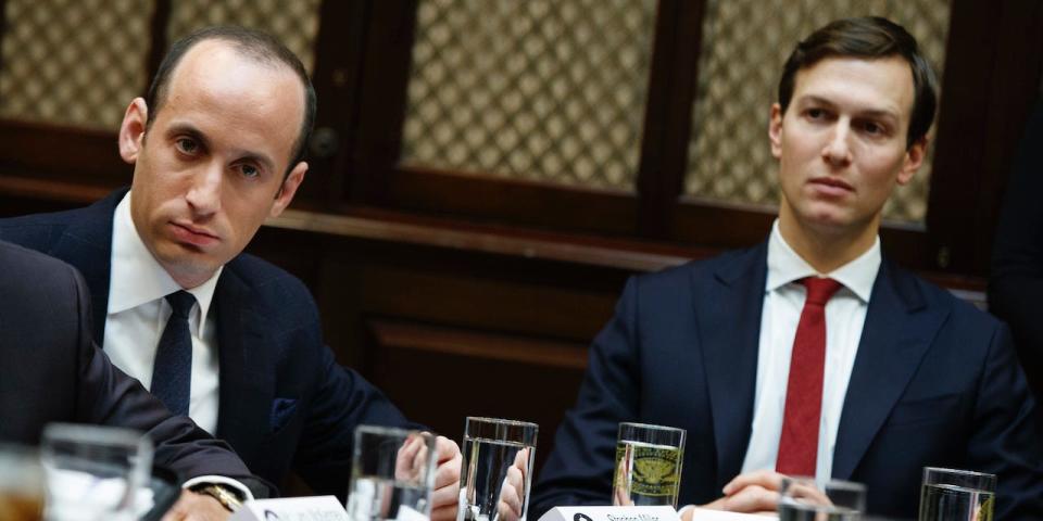 Senior Advisers to President Donald Trump Stephen Miller, left, and Jared Kushner, listen as Trump speaks during a meeting with business leaders in the Roosevelt Room of the White House in Washington, Monday, Jan. 30, 2017.