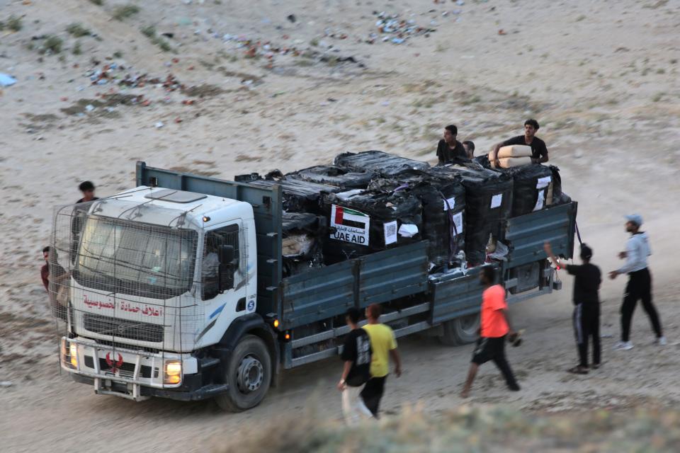 A truck is rushed as it transports international humanitarian aid from the US-built Trident Pier in the central Gaza Strip.