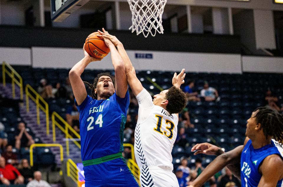 FGCUÕs Andre Weir drives to the basket against DrexelÕs Garfield Turner during the 2022 Gulf Coast Showcase at Hertz Arena. FGCU won 67-59 and moves on to the finals against Kansas City.  Weir was fouled. 