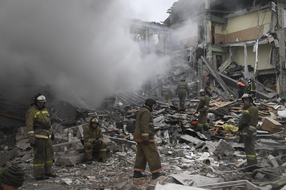 Donetsk's emergency employees work at a site of a shopping center destroyed after what Russian officials in Donetsk said it was a shelling by Ukrainian forces, in Donetsk, in Russian-controlled Donetsk region, eastern Ukraine, Monday Jan. 16, 2023. (AP Photo)