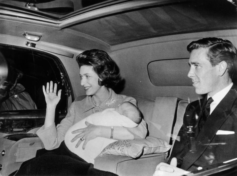 Margaret cradling her newborn son David Albert Armstrong-Jones (Viscount Linley) with husband Antony Armstrong-Jones, Earl of Snowdon, at their side.