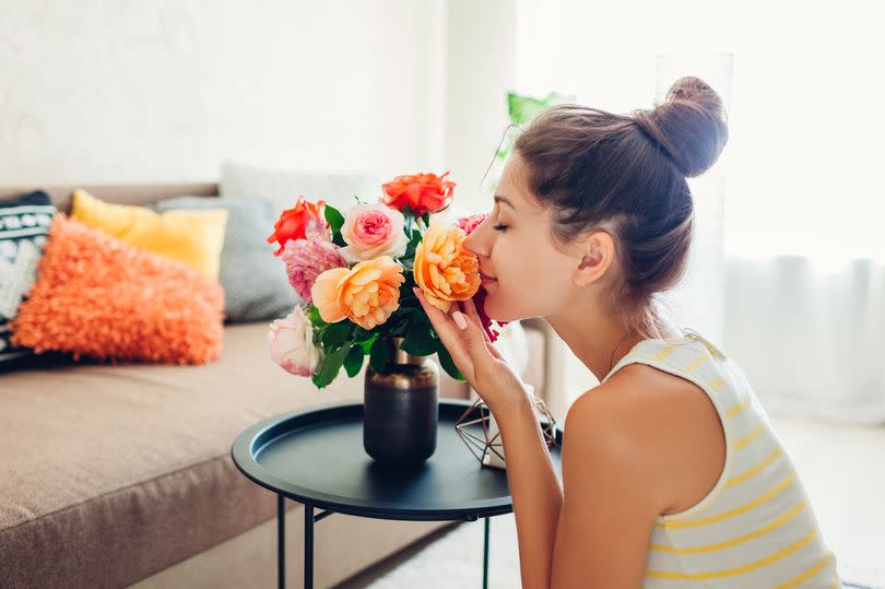 Woman smelling roses