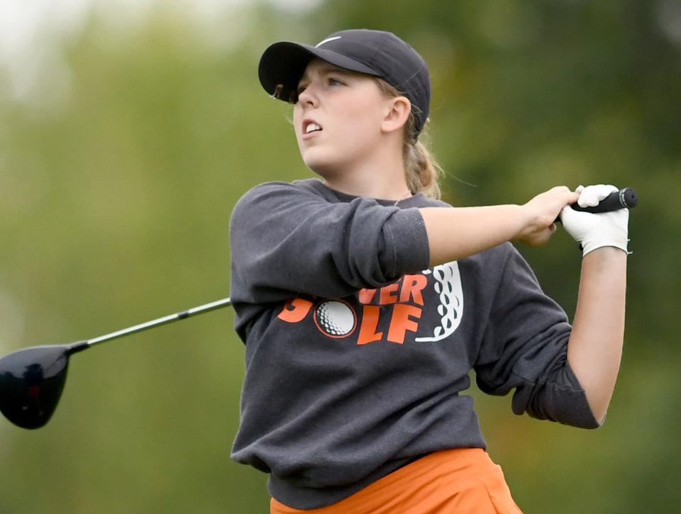 Hoover's Ava Kemp watches her shot after teeing off on No. 10 in the Federal League Girls Golf Postseason Tournament at The Elms Country Club, Tuesday, Sept. 26, 2023.