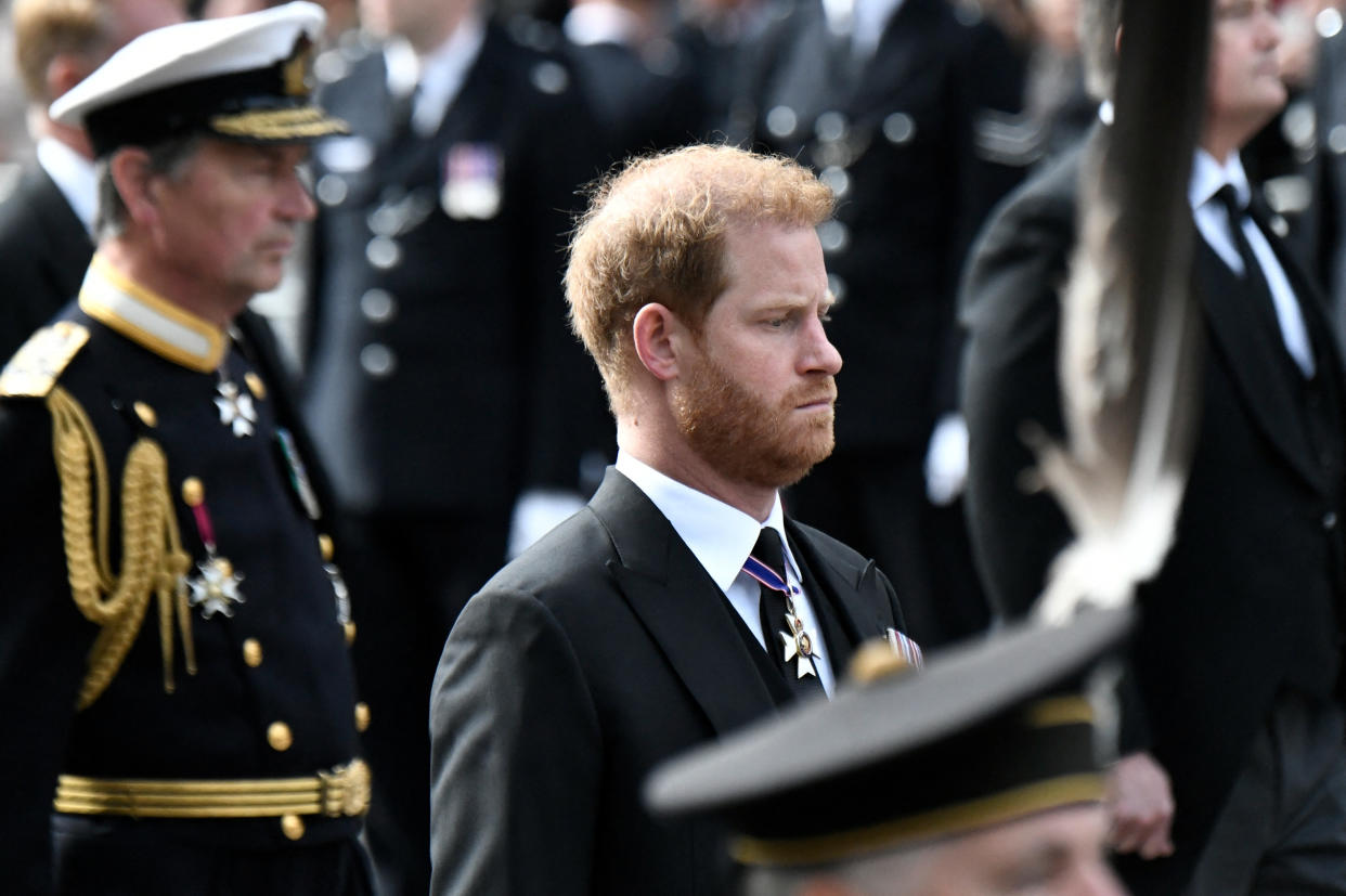 Britain's Prince Harry, Duke of Sussex follows the coffin of Queen Elizabeth II, draped in the Royal Standard, on the State Gun Carriage of the Royal Navy, as it travels from Westminster Abbey to Wellington Arch in London on September 19, 2022, after the State Funeral Service of Britain's Queen Elizabeth II. - Leaders from around the world attended the state funeral of Queen Elizabeth II. The country's longest-serving monarch, who died aged 96 after 70 years on the throne, was honoured with a state funeral on Monday morning at Westminster Abbey.     STEPHANE DE SAKUTIN/Pool via REUTERS
