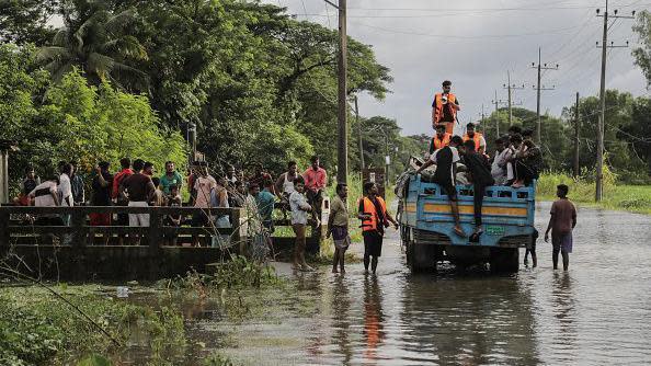 Volunteers try to make a que before delivering relief food package in Feni, Chittagong, Bangladesh, August 26, 2024.