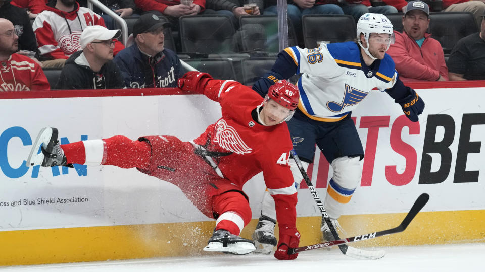 St. Louis Blues left wing Nathan Walker (26) checks Detroit Red Wings right wing Alex Chiasson (48) in the first period of an NHL hockey game Thursday, March 23, 2023, in Detroit. (AP Photo/Paul Sancya)