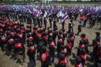 Members of the "Volunteers' Ward to protect the Nation's Democracy" group march as they mark the end of their two days training at the stadium in Nakhon Ratchasima, Northeastern province of Thailand, April 21, 2014. REUTERS/Athit Perawongmetha