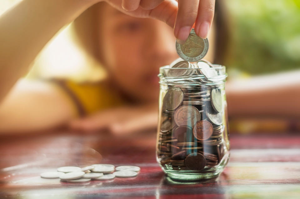 Save money and account banking for finance business concept, Girl with coin money on blurred background. Source: Getty Images