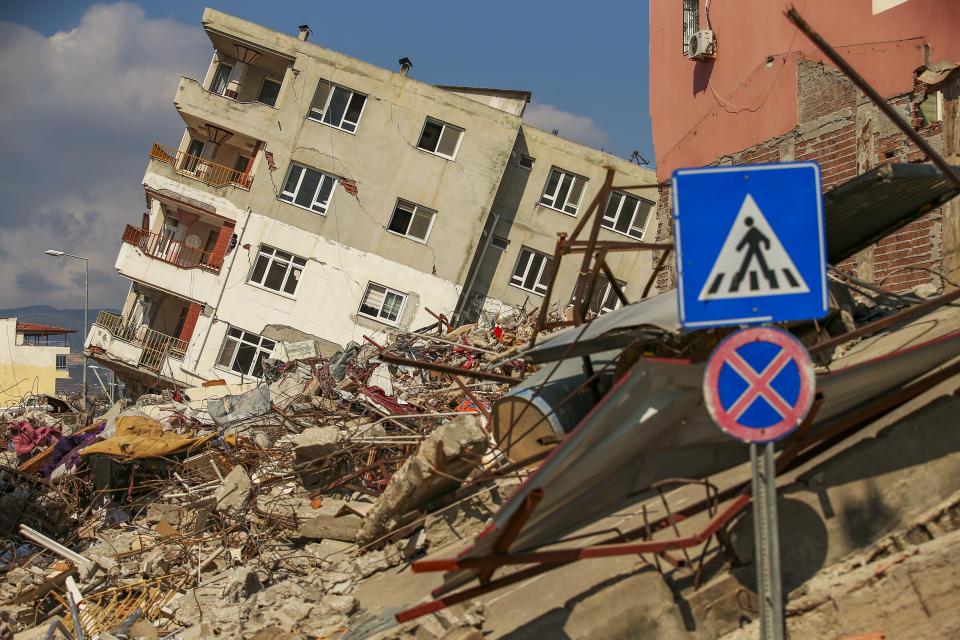 A destroyed building leans on a neighbouring house following the earthquake in Samandag, southern Turkey, Wednesday, Feb. 22, 2023. Survivors of the earthquake that jolted Turkey and Syria 15 days ago, killing tens of thousands of people and leaving hundreds of thousands of others homeless, dealt with more trauma and loss Tuesday after another deadly quake and aftershocks rocked the region. (AP Photo/Emrah Gurel)