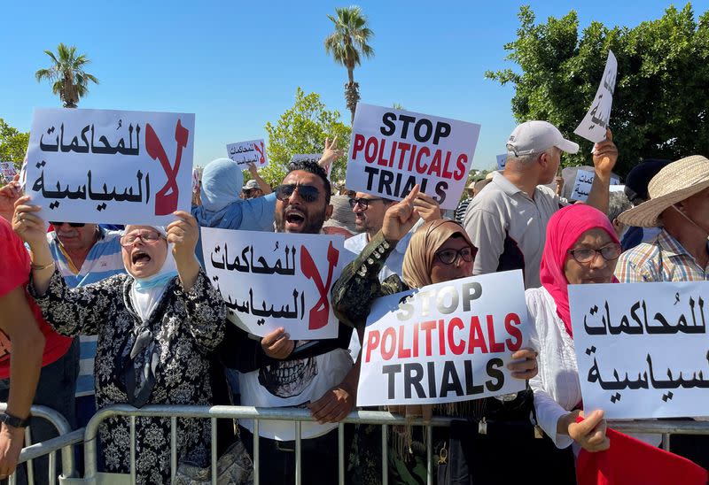 Supporters of Tunisia's Islamist movement leader Rached Ghannouchi protest outside a court in Tunis