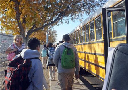 Students from Sparks Middle School go to waiting buses to be transported to Sparks High School after the school shooting to be reunited with their parents in Sparks, Nevada, October 21, 2013. REUTERS/Marilyn Newton/Reno Gazette-Journal