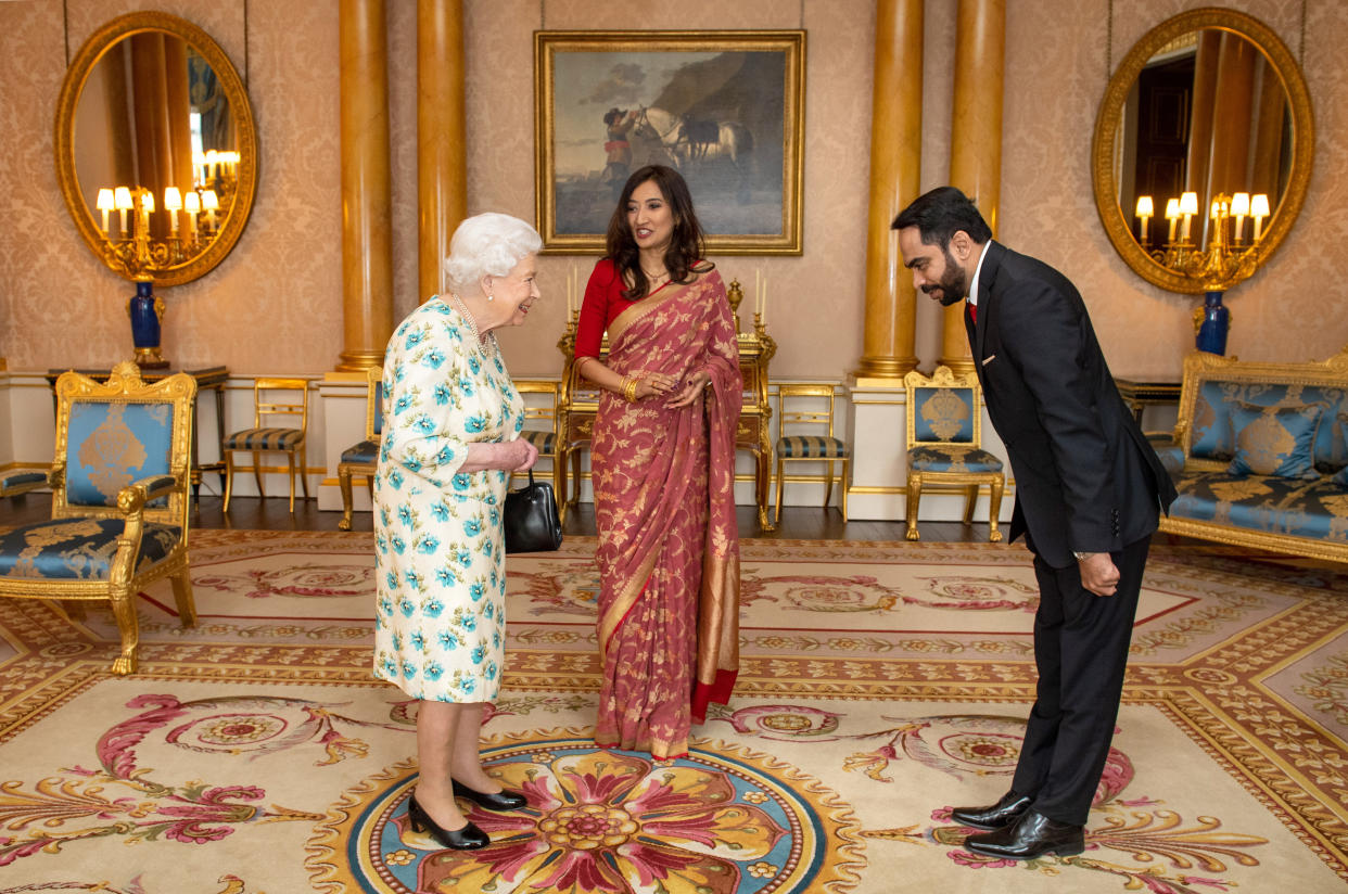 Queen Elizabeth II meets meets High Commissioner of Sri Lanka Saroja Sirisena and Sudath Talpahewa (right) during an audience at Buckingham Palace, London.