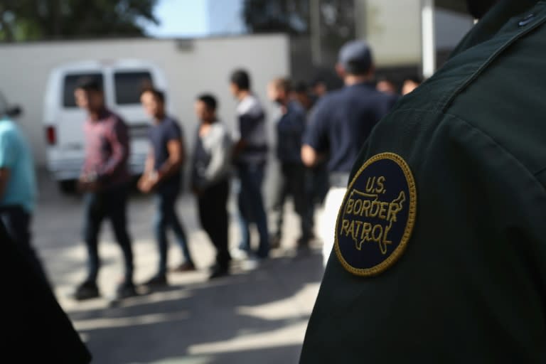 Undocumented immigrants, wearing shackles, are seen in a detention center in McAllen, Texas