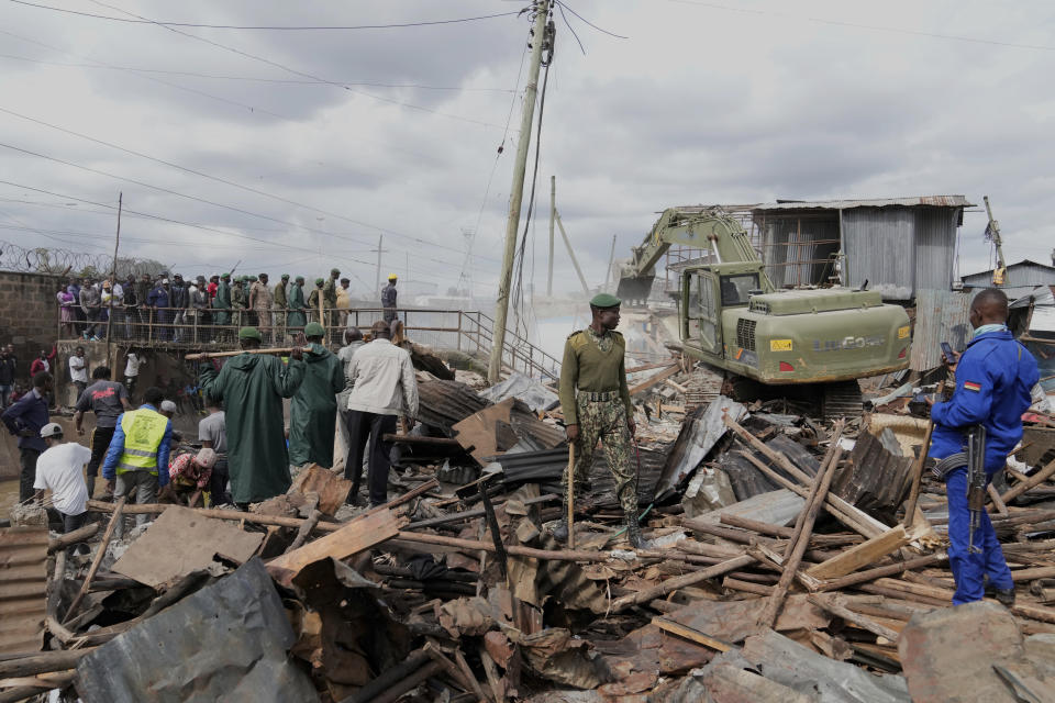 A bulldozer demolishes houses during a government ordered demolition of illegally constructed structures on riparian land in the Mukuru area of Nairobi, Kenya, Tuesday, May 7, 2024. (AP Photo/Brian Inganga)