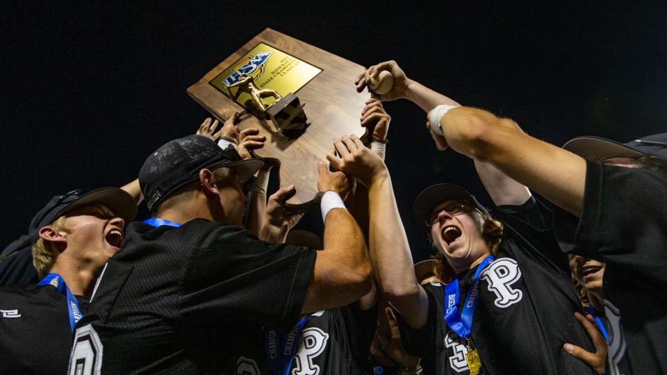 The Penn Kingsman celebrate their win over the Cathedral Irish in the state championship baseball game Saturday, June 18, 2022 at Victory Field in Indianapolis. 