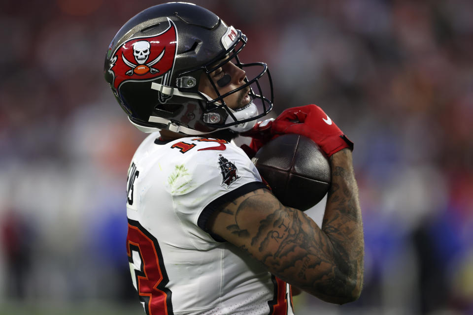 Tampa Bay Buccaneers wide receiver Mike Evans (13) scores against the Los Angeles Rams during the second half of an NFL divisional round playoff football game Sunday, Jan. 23, 2022, in Tampa, Fla. (AP Photo/Mark LoMoglio)