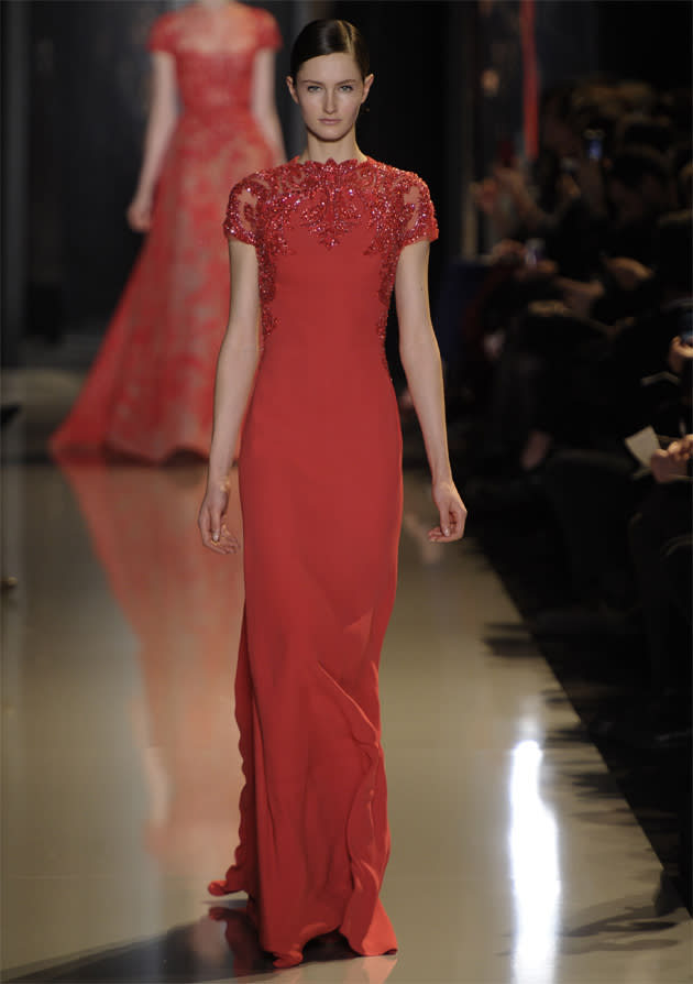 <b>Elie Saab SS13 </b><br><br>Red added colour to the neutral-themed collection, with gorgeous full length gowns such as this, with sparkling jewelled detail at the collar and sleeves.<br><br>©Rex