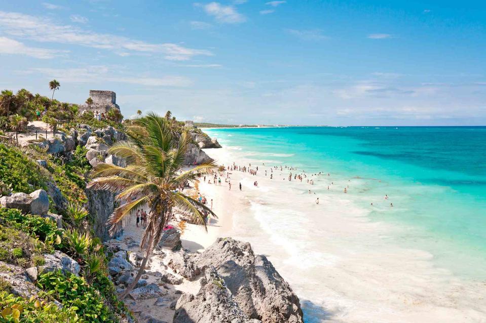 <p>M Swiet Productions/Getty Images</p> People enjoying the white sand and turquoise water of Tulum Beach in Tulum, Mexico  