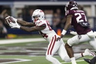 Arkansas wide receiver Warren Thompson (84) scores a touchdown as Texas A&M defensive back Antonio Johnson (27) defends during the first half of an NCAA college football game Saturday, Sept. 24, 2022, in Arlington, Texas. (AP Photo/Brandon Wade)