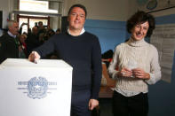 Italian Prime Minister Matteo Renzi casts his vote for the referendum on constitutional reform as he is flanked by his wife Agnese, in Pontassieve, near Florence, northern Italy December 4, 2016. REUTERS/Leonardo Bianchi