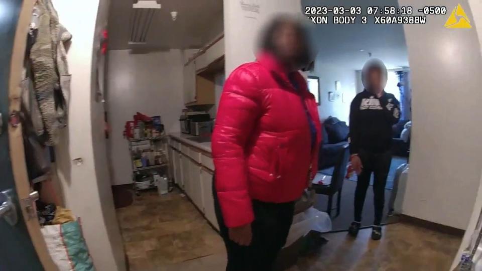 A still image taken from police body cam released in the Najee Seabrooks case showing moments when officers first arrived at the Mill St. apartment in response to a 911 call by Seabrooks. Here, an officer speaks with two people inside the apartment.