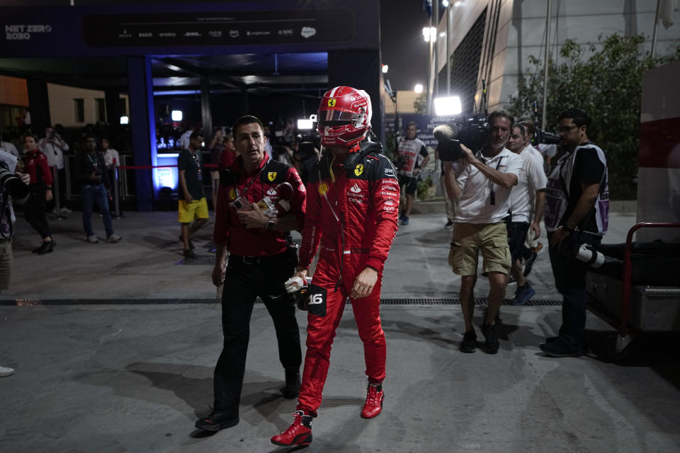 Ferrari driver Charles Leclerc of Monaco walks back to the pit lane after his car stalled in action during the Formula One Bahrain Grand Prix at Sakhir circuit, Sunday, March 5, 2023. (AP Photo/Frank Augstein)