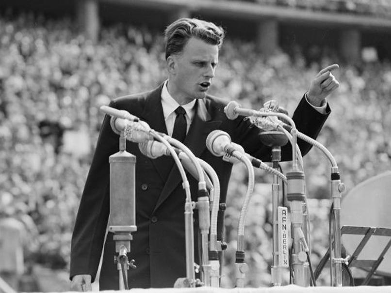 In this June 27, 1954 file photo, Evangelist Billy Graham speaks to over 100,000 people at the Olympic Stadium in Berlin, Germany: AP