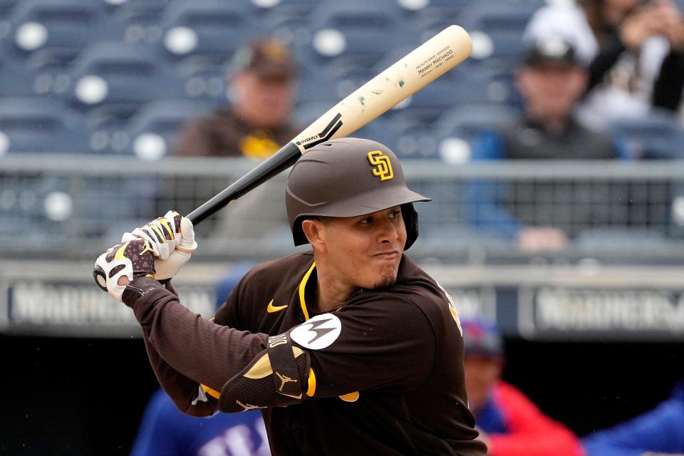 San Diego Padres' Manny Machado bats during the first inning of a spring training baseball game against the Texas Rangers Wednesday, March 1, 2023, in Peoria, Ariz. (AP Photo/Charlie Riedel)