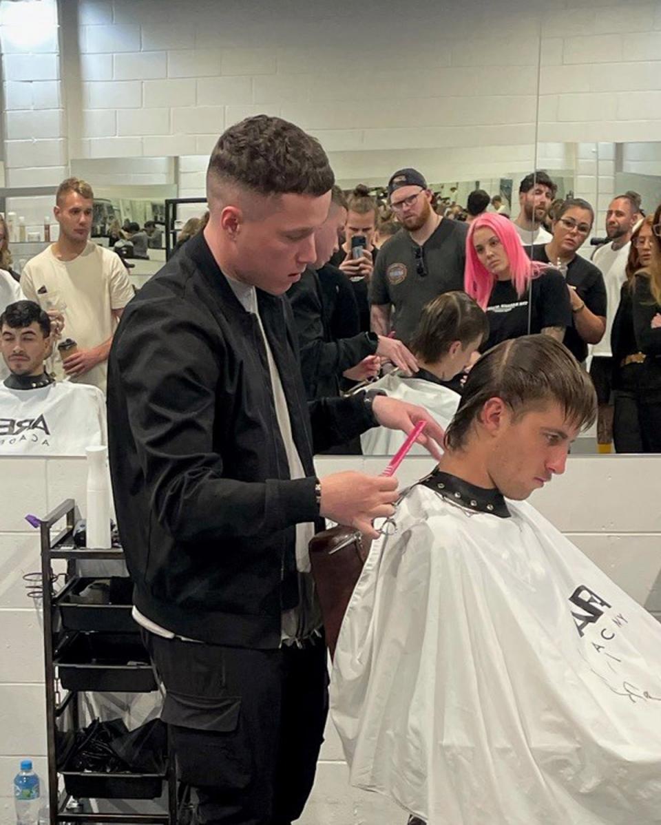 Mr Hawthorne giving a demonstration of his barbering skills (Mark Hawthorne/PA) (PA Media)