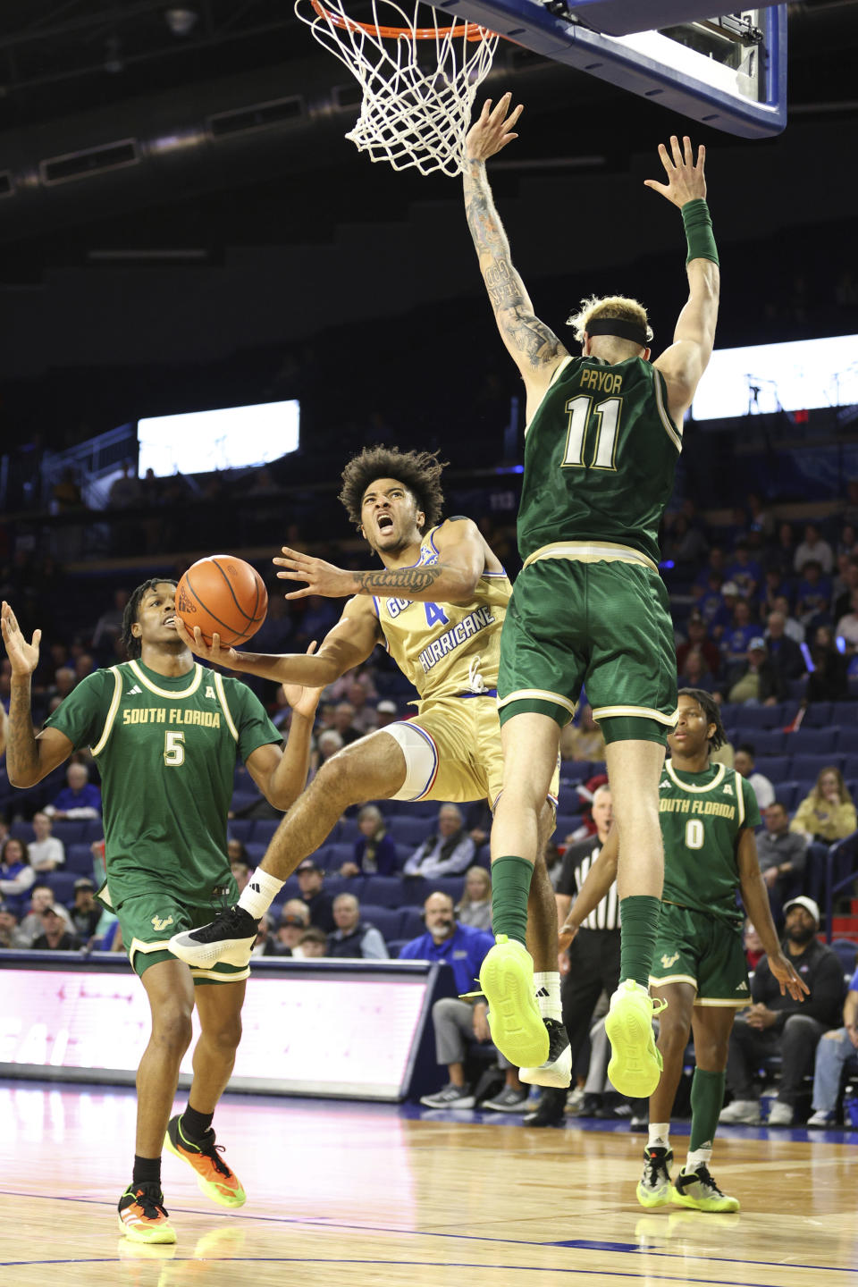 Tulsa guard PJ Haggerty (4) shoots around South Florida forward Kasean Pryor (11) during the second half of an NCAA college basketball game, Saturday, March 9, 2024, in Tulsa, Okla. (AP Photo/Joey Johnson)