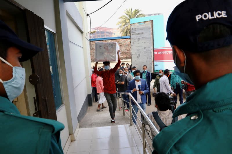 A worker carries a package of Oxford-Astrazeneca COVID-19 vaccines that arrived from India as a gift to Bangladesh, in Dhaka