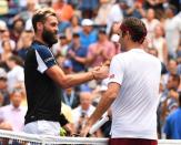 Aug 30, 2018; New York, NY, USA; Roger Federer of Switzerland (right) reacts after beating Benoit Paire of France (left) a second round match on day four of the 2018 U.S. Open tennis tournament at USTA Billie Jean King National Tennis Center. Mandatory Credit: Robert Deutsch-USA TODAY Sports