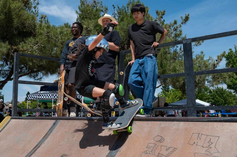 Anna Reynolds-Madsen, 9, performs tricks on the ramp after the ribbon cutting ceremony for the Tyre Nichols Skate Park, named in honor of the former Sacramento resident who was fatally beaten by Memphis police officers following a traffic stop in January, on Sunday at Regency Community Park in Sacramento.