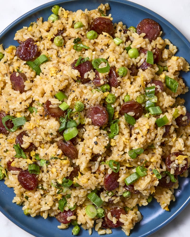 Overhead shot of Chinese sausage fried rice on a blue plate.