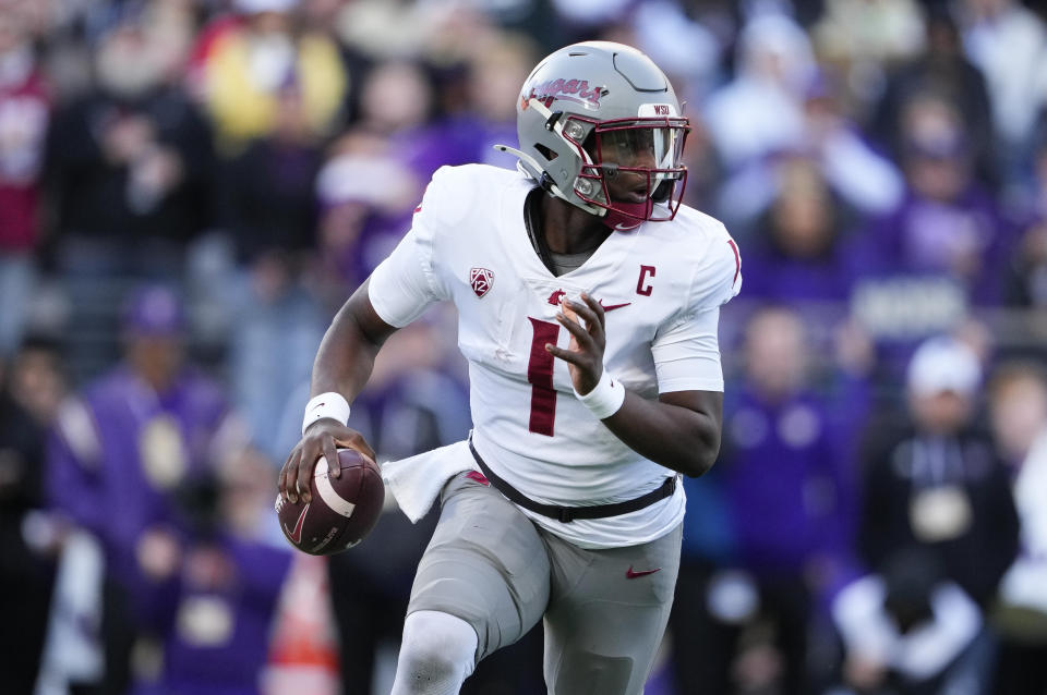 Washington State quarterback Cameron Ward (1) runs with the ball against Washington during the first half of an NCAA college football game, Saturday, Nov. 25, 2023, in Seattle. (AP Photo/Lindsey Wasson)