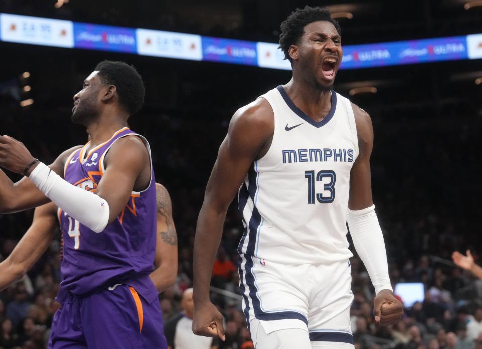 Memphis Grizzlies forward Jaren Jackson Jr. (13) yells out after scoring and being fouled by Phoenix Suns forward Chimezie Metu (4) at the Footprint Center in Phoenix on Jan. 7, 2024.