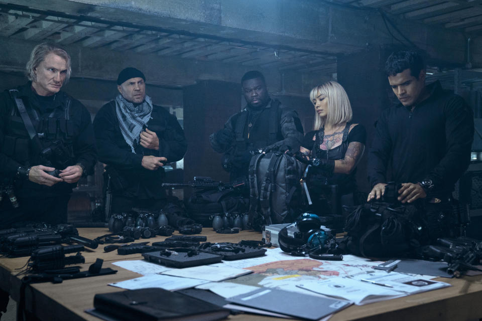 This image released by Lionsgate shows Dolph Lundgren, from left, Randy Couture, Curtis Jackson, Levy Tran and Jacob Scipio in a scene from "The Expend4bles." (Lionsgate via AP)