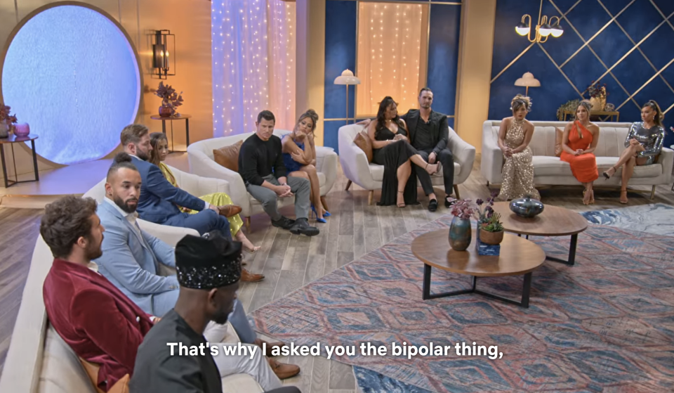 The cast sitting in the semicircle with the text "That's why I asked you the bipolar thing"