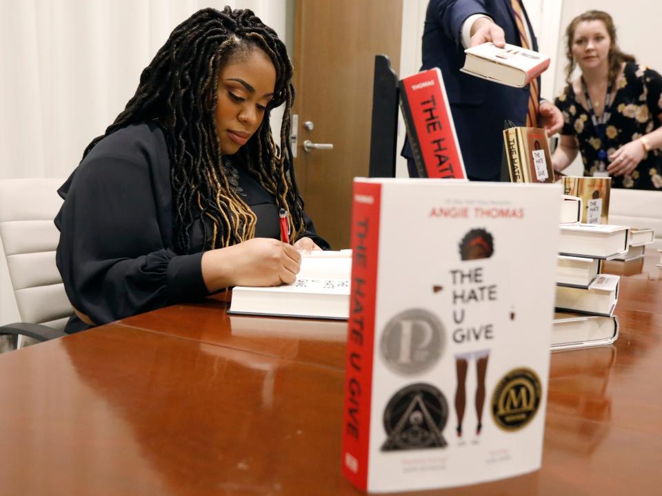 Author Angie Thomas signs copies of "The Hate U Give" at a book signing